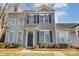 Two-story townhome with gray siding, black shutters, and landscaping at 104 N Canyon Ridge Dr, Mount Holly, NC 28120