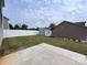 A fenced backyard with grass and a concrete patio, perfect for outdoor entertaining at 104 Sycamore Crossing Ct, Locust, NC 28097