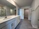 Bright bathroom featuring a double sink vanity with white cabinets and a neutral color palette at 104 Sycamore Crossing Ct, Locust, NC 28097