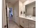 Bright bathroom with a double sink vanity, large mirror, and access to a tiled shower at 104 Sycamore Crossing Ct, Locust, NC 28097