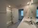 A well-lit bathroom features double sinks, a shower, and a neutral color scheme at 104 Sycamore Crossing Ct, Locust, NC 28097