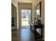 Welcoming entryway with wood floors, console table, and a view to the outside at 104 Sycamore Crossing Ct, Locust, NC 28097