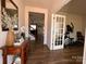 Inviting home entryway featuring wood floors, a decorative table, and open doorway views at 104 Sycamore Crossing Ct, Locust, NC 28097