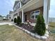 Welcoming front porch with stone accents and manicured landscaping at 104 Sycamore Crossing Ct, Locust, NC 28097