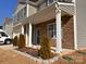 Attractive home exterior showcasing stone accents, gray siding, and manicured landscaping at 104 Sycamore Crossing Ct, Locust, NC 28097