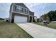Charming two-story home with stone accents, a two-car garage, and a well-manicured front yard at 104 Sycamore Crossing Ct, Locust, NC 28097