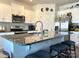 Kitchen with stainless steel appliances, granite countertops, and an island with bar stools at 104 Sycamore Crossing Ct, Locust, NC 28097