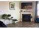 Cozy living room featuring a fireplace, hardwood floors, and a flat screen television at 104 Sycamore Crossing Ct, Locust, NC 28097