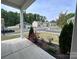 Picturesque neighborhood view from the porch with manicured landscaping and charming homes at 104 Sycamore Crossing Ct, Locust, NC 28097