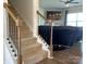 Carpeted staircase with wooden railing leading to the upper level at 104 Sycamore Crossing Ct, Locust, NC 28097