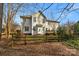 Exterior backyard view featuring a wooden fence and mature trees at 10417 Sutherby Dr, Charlotte, NC 28277