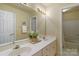 Well-lit bathroom with a double sink vanity and neutral wall color at 10417 Sutherby Dr, Charlotte, NC 28277