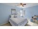 Bright bedroom featuring light blue walls, a ceiling fan, and large windows at 10417 Sutherby Dr, Charlotte, NC 28277