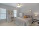 Bedroom with a ceiling fan and a built-in shelving unit next to the window at 10417 Sutherby Dr, Charlotte, NC 28277