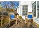 Inviting wooden deck with rocking chairs and side table perfect for relaxing outdoors at 10417 Sutherby Dr, Charlotte, NC 28277