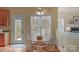 Cozy dining area featuring a wooden table, four chairs, and natural light from the window at 10417 Sutherby Dr, Charlotte, NC 28277