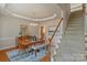 Inviting dining room features hardwood floors, a chandelier, and a staircase with white railings at 10417 Sutherby Dr, Charlotte, NC 28277