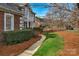 Beautifully landscaped front yard with lush greenery, decorative shrubbery, and a charming walkway at 10417 Sutherby Dr, Charlotte, NC 28277