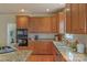 Close-up view of the kitchen's granite countertops, wooden cabinets, and built-in appliances at 10417 Sutherby Dr, Charlotte, NC 28277