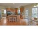 This open kitchen features wood cabinets, granite countertops, and stainless steel appliances at 10417 Sutherby Dr, Charlotte, NC 28277