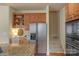 A well-equipped kitchen with a stainless steel refrigerator, built-in oven, and ample cabinet space at 10417 Sutherby Dr, Charlotte, NC 28277