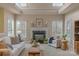 Cozy living room with a fireplace, neutral furniture, and bright windows that create a relaxing atmosphere at 10417 Sutherby Dr, Charlotte, NC 28277