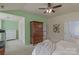 Spacious main bedroom with a wooden cabinet, ceiling fan, and connecting bathroom, offering a relaxing retreat at 10417 Sutherby Dr, Charlotte, NC 28277