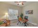 Inviting home office featuring a wooden desk, comfortable chair, and natural light from a large window at 10417 Sutherby Dr, Charlotte, NC 28277