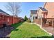 A well-kept backyard features a brick fence, manicured lawn, and wooden deck at 105 Plantation Ct, Shelby, NC 28150