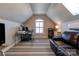 An upstairs bedroom is decorated with an area rug, desk, chair, and window in this well-lit living space at 105 Plantation Ct, Shelby, NC 28150