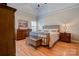 Cozy bedroom featuring a metal bed frame, hardwood floors, and neutral décor with matching night stands at 105 Plantation Ct, Shelby, NC 28150