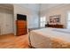 Bedroom featuring a metal bed frame, hardwood floors, and neutral décor with a dresser and a large window at 105 Plantation Ct, Shelby, NC 28150