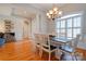 Bright dining room with hardwood floors, chandelier, wainscoting, and a classic dining set at 105 Plantation Ct, Shelby, NC 28150