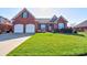 Charming brick home featuring a two-car garage, lush lawn, and manicured landscaping at 105 Plantation Ct, Shelby, NC 28150