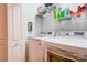 Modern laundry room equipped with high-efficiency washer and dryer and overhead shelving at 105 Plantation Ct, Shelby, NC 28150