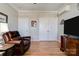 Comfortable living room featuring hardwood floors, a leather chair, and interior doors at 105 Plantation Ct, Shelby, NC 28150