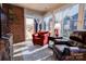 Cozy sunroom featuring brick walls, tile floors, comfortable seating, and abundant natural light at 105 Plantation Ct, Shelby, NC 28150