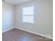 Simple bedroom with hardwood floors and a window with blinds at 1127 Ansonville Rd, Wingate, NC 28174