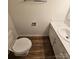 Compact bathroom featuring a toilet, sink, and vanity with marble-look countertop at 11433 Kingfisher Dr, Charlotte, NC 28226