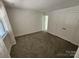 Spacious bedroom featuring neutral carpet, multiple windows and a closet at 11433 Kingfisher Dr, Charlotte, NC 28226