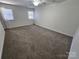 Bright, carpeted bedroom with multiple windows and a ceiling fan at 11433 Kingfisher Dr, Charlotte, NC 28226