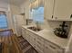 Bright kitchen featuring white subway tile backsplash and stainless steel sink at 11433 Kingfisher Dr, Charlotte, NC 28226