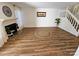 Bright living room features hardwood floors, fireplace, and staircase at 11433 Kingfisher Dr, Charlotte, NC 28226