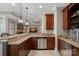 Bar area featuring granite countertops, cherry cabinets, and stainless steel appliances at 134 Wild Harbor Rd, Mooresville, NC 28117