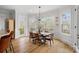 Dining room featuring hardwood floors, wainscotting, large windows, and a modern light fixture at 134 Wild Harbor Rd, Mooresville, NC 28117