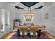 Elegant dining room featuring tray ceilings, hardwood floors, and designer lighting for sophisticated entertaining at 134 Wild Harbor Rd, Mooresville, NC 28117