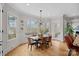 Dining room featuring hardwood floors, wainscotting, large windows, and a modern light fixture at 134 Wild Harbor Rd, Mooresville, NC 28117