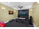 Home gym featuring workout equipment, a television, and rubber flooring at 134 Wild Harbor Rd, Mooresville, NC 28117