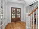 Elegant foyer with hardwood floors, a staircase, wainscoting, and double doors offering a warm welcome at 134 Wild Harbor Rd, Mooresville, NC 28117