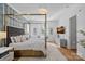 Main bedroom showcasing hardwood floors, a four poster bed, sitting area, and a modern ceiling fan at 134 Wild Harbor Rd, Mooresville, NC 28117